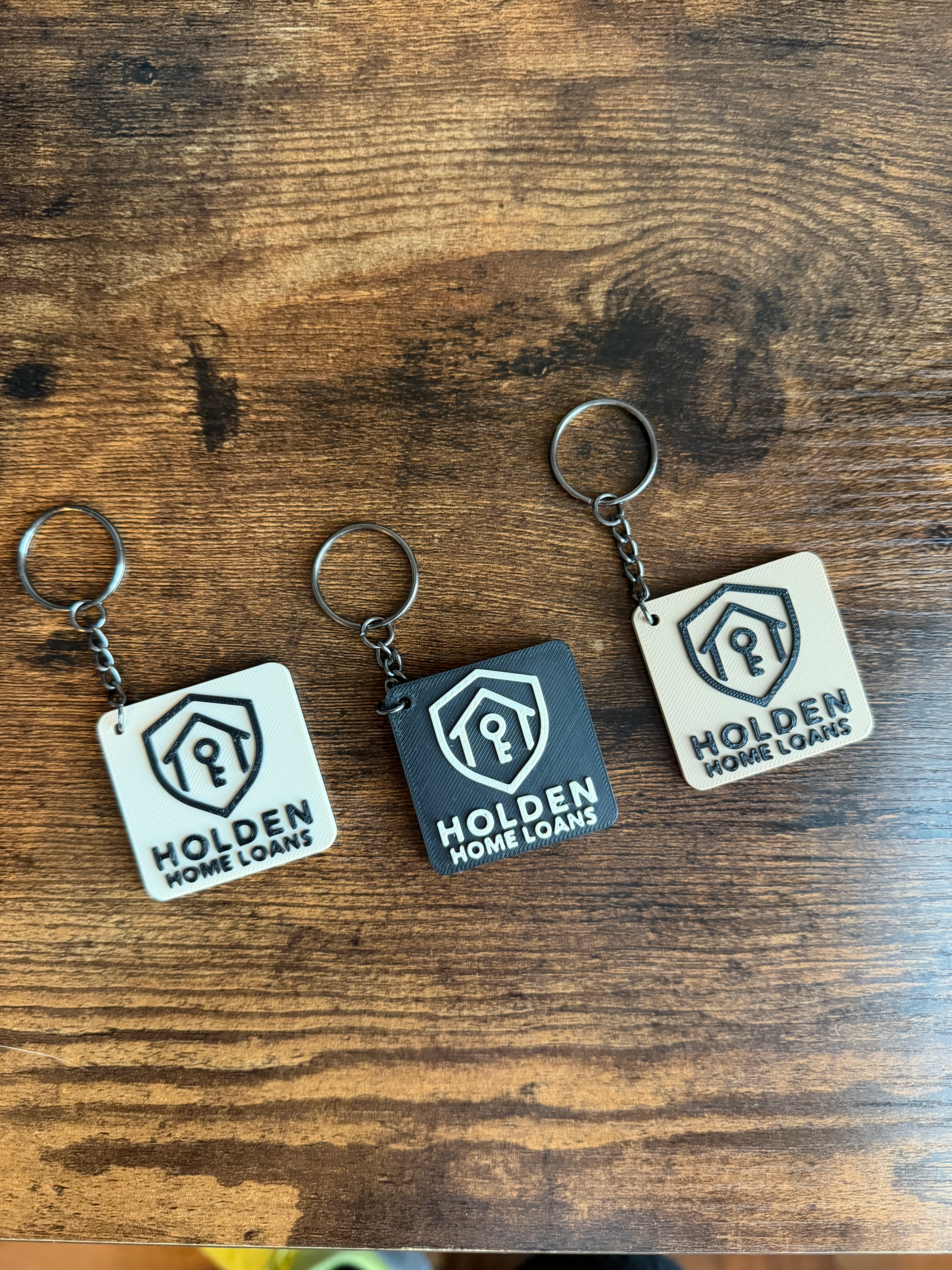 Custom NFC keychains in white, dark, and tan colorways