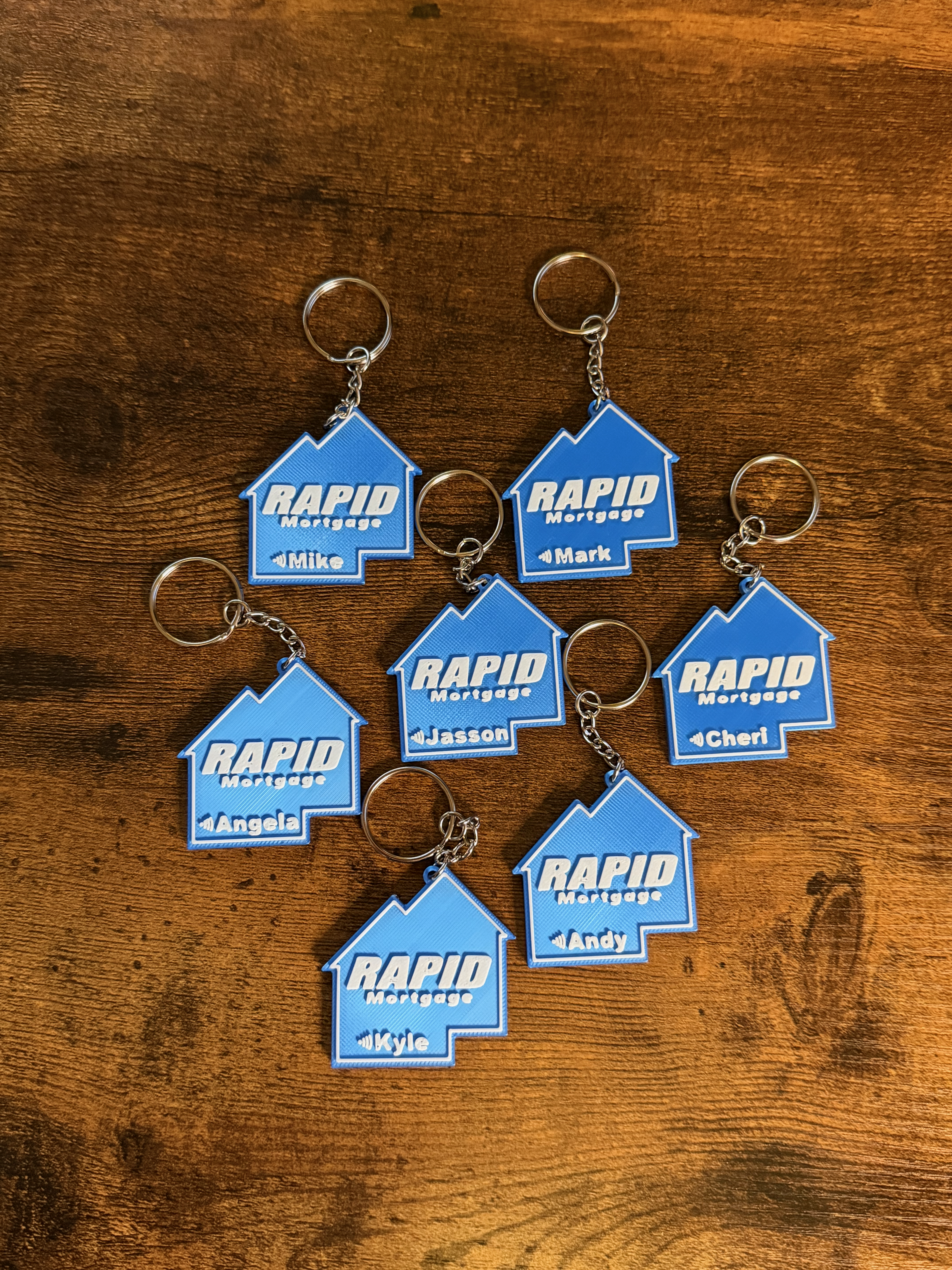 Seven matching house-shaped NFC keychains, each personalized with a different name