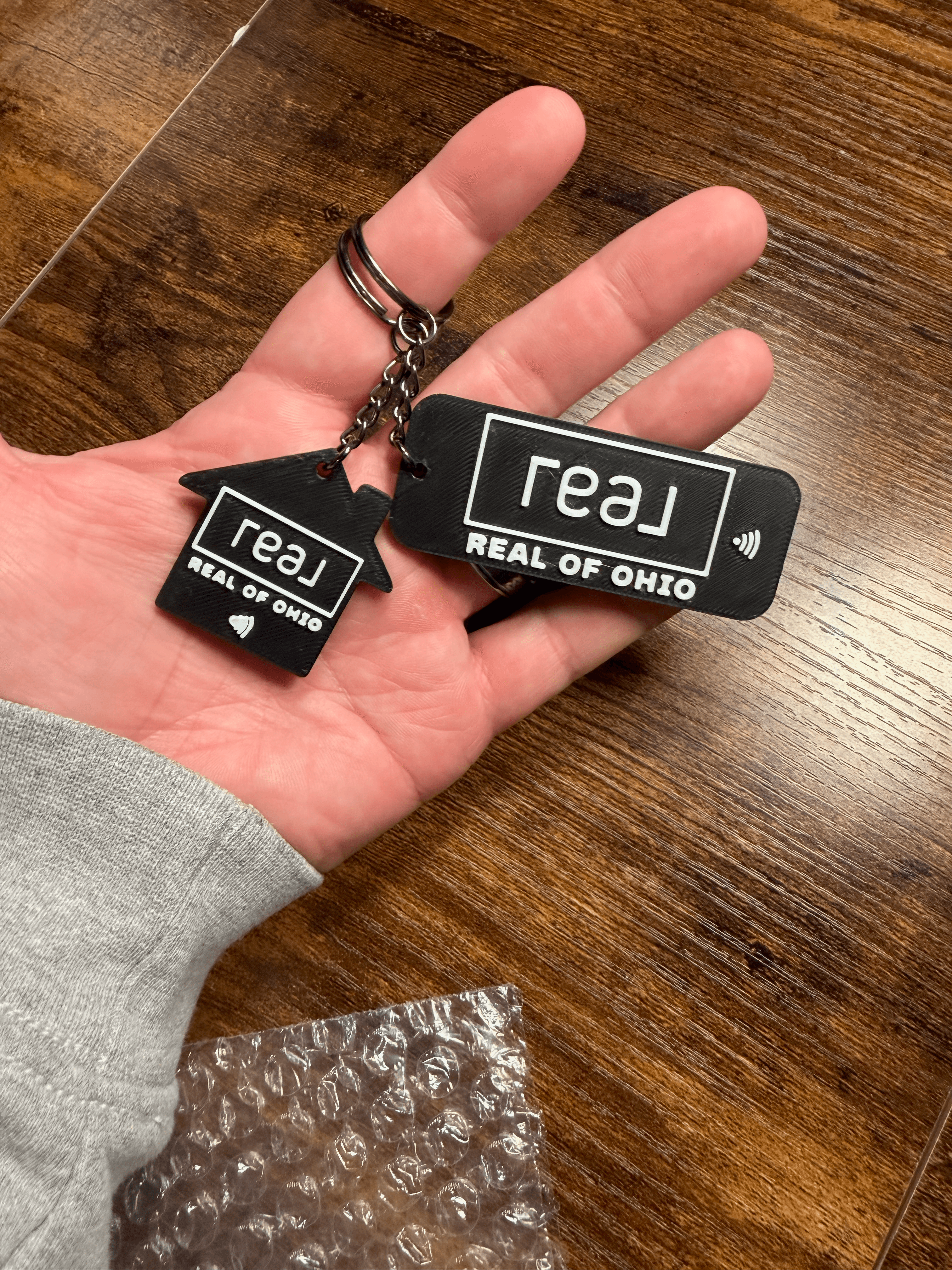 House and rectangle NFC tags held in hand